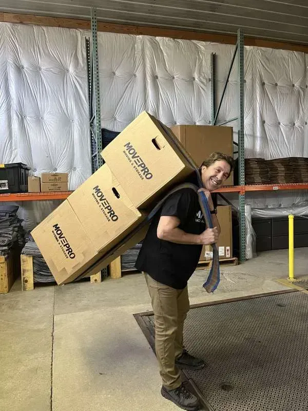 MovePro movers carrying packed boxes during a residential move in Northeast Indiana