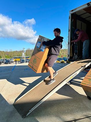 MovePro team coordinating a residential move outside a home in Fort Wayne