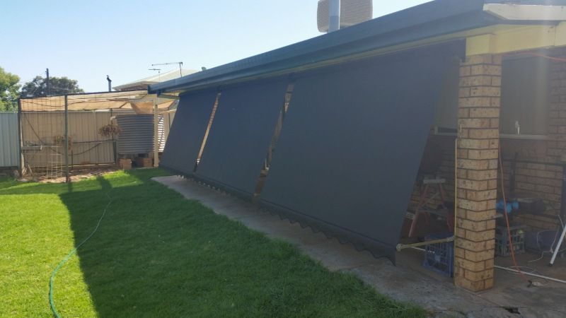 A House With a Brick Porch and a Lawn in Front of It — BTS Blinds & Awnings in Singleton, NSW