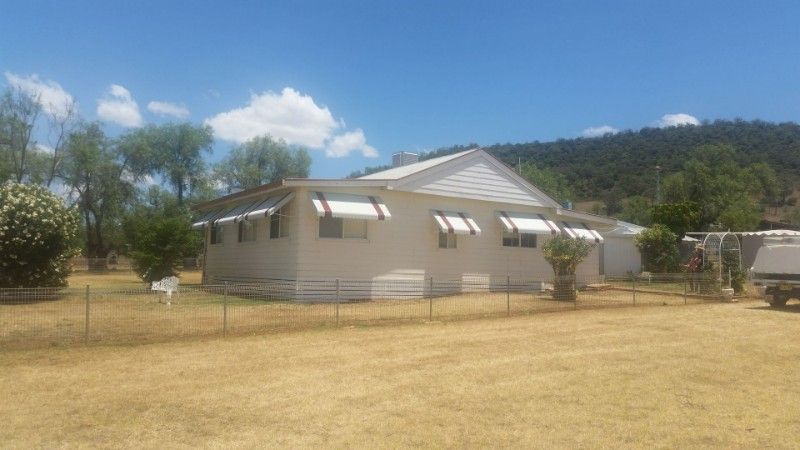 A White House is Sitting in the Middle of a Dry Grass Field — BTS Blinds & Awnings in Gunnedah, NSW