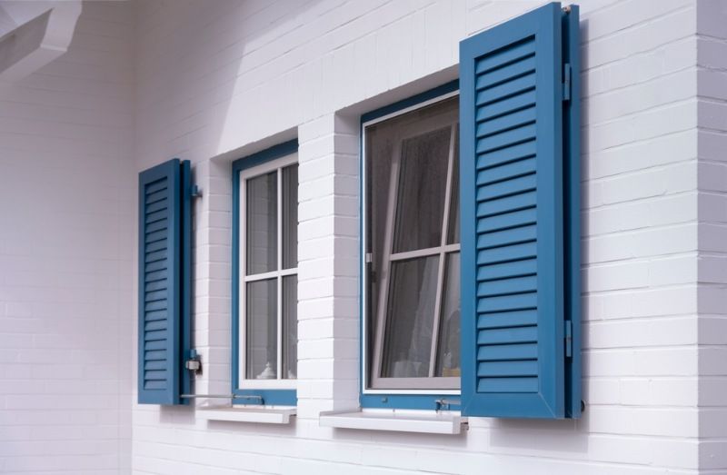 A White Building With Blue Shutters on the Windows — BTS Blinds & Awnings in Singleton, NSW