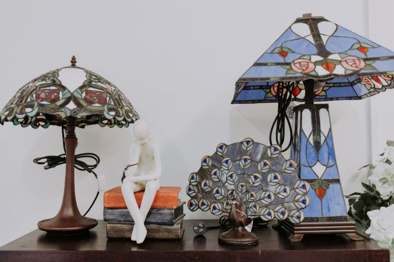 Two Lamps Are Sitting on a Table Next to a Peacock Statue — BTS Blinds & Awnings in Gunnedah, NSW