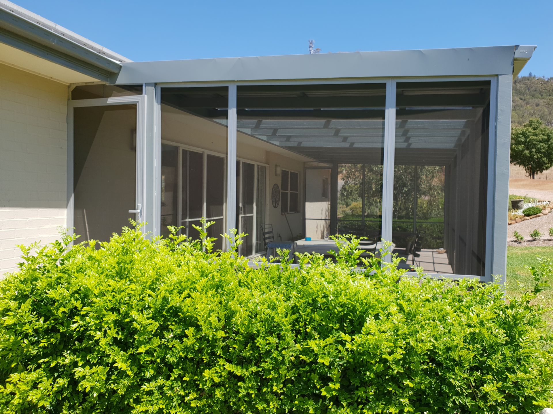 A Statue of a Woman is Sitting in Front of a Window With Blinds — BTS Blinds & Awnings in Gunnedah, NSW
