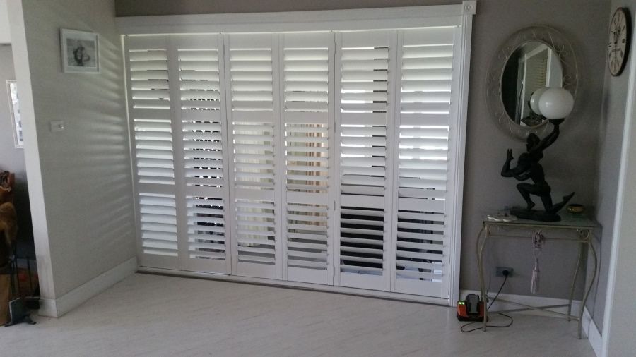 A Room With White Shutters on the Doors and a Mirror — BTS Blinds & Awnings in Gunnedah, NSW