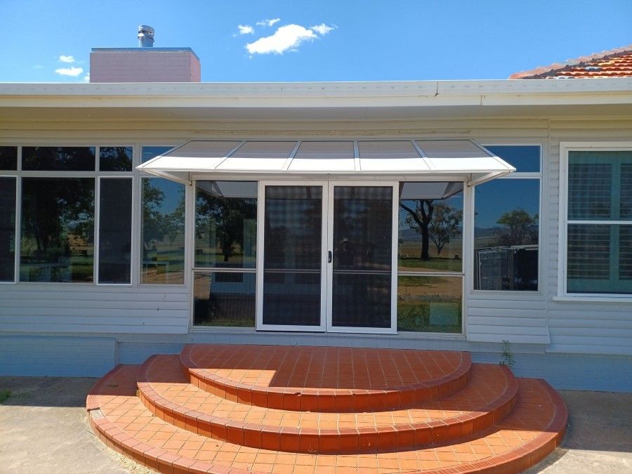 A house with stairs leading up to the front door — BTS Blinds & Awnings in Moree, NSW