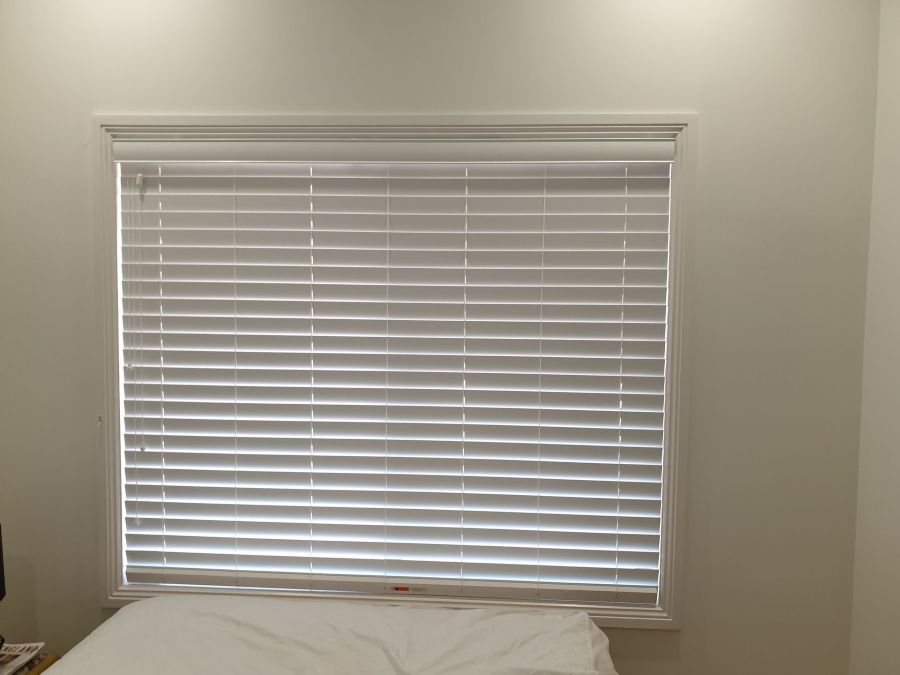A Bedroom With a Bed and a Window With Blinds — BTS Blinds & Awnings in Gunnedah, NSW