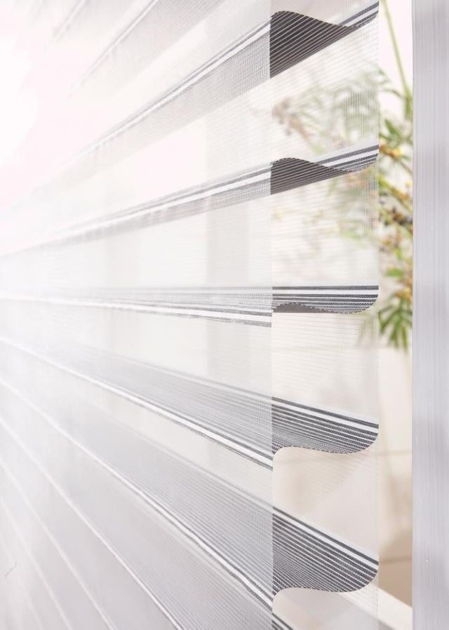 A Close Up of a Window Blind With a Plant in the Background — BTS Blinds & Awnings in Gunnedah, NSW