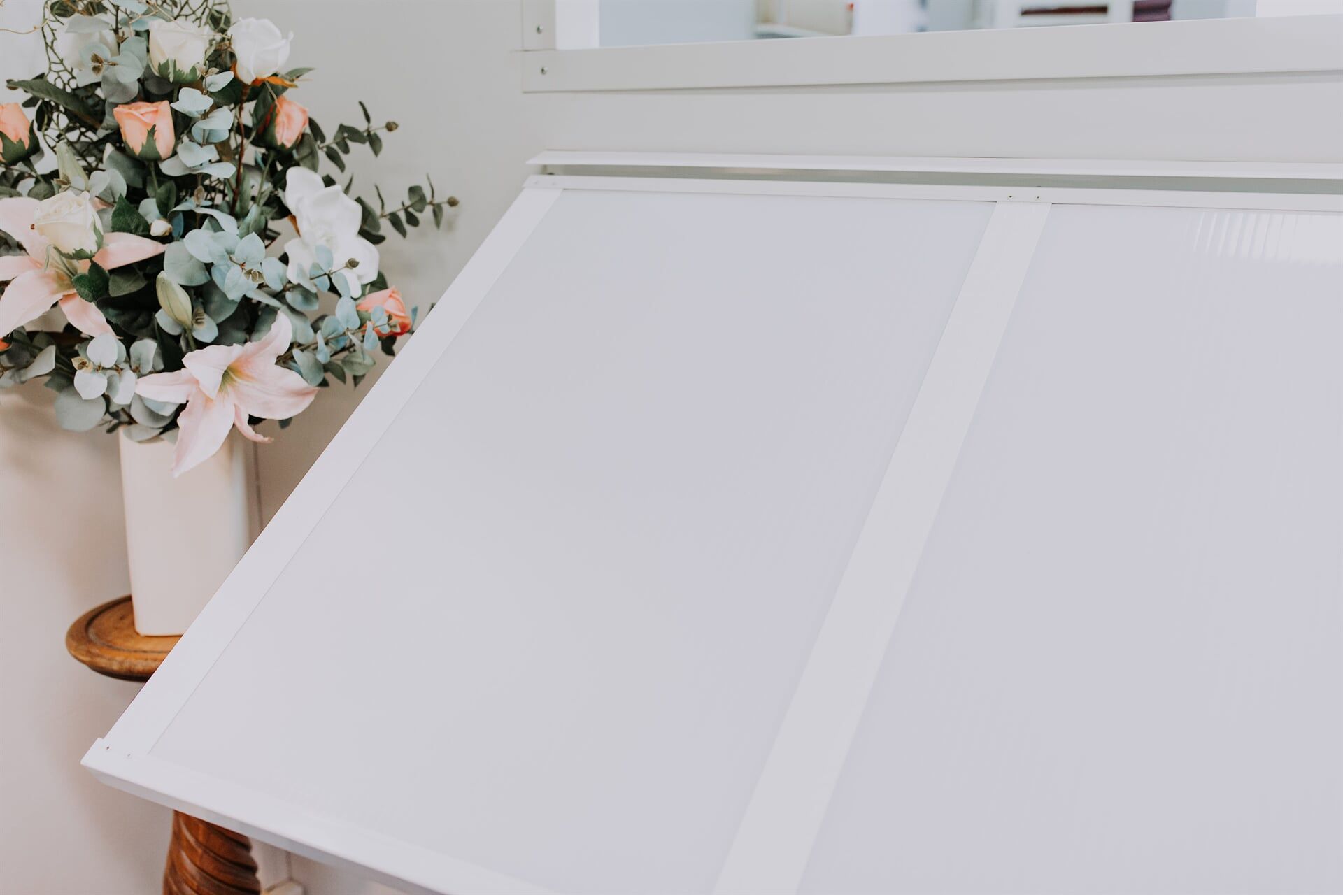 A White Table With a Vase of Flowers on It — BTS Blinds & Awnings in Gunnedah, NSW