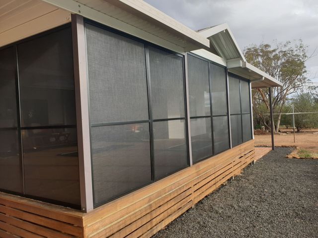 A Screened in Porch With a Wooden Deck — BTS Blinds & Awnings in Gunnedah, NSW
