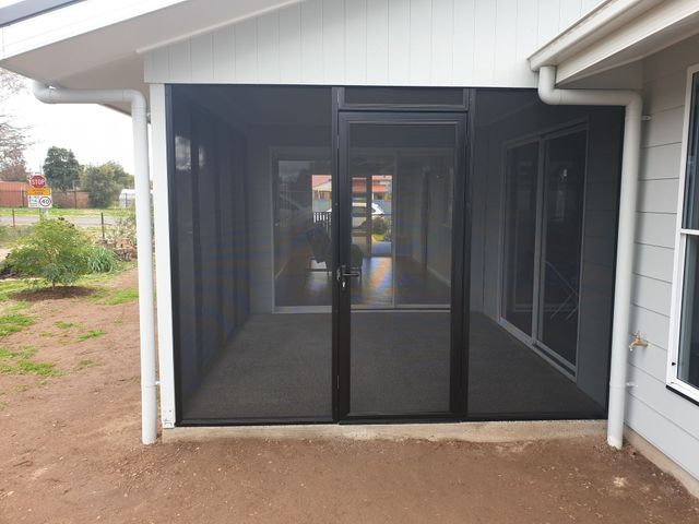 A Screened in Porch With a Black Screen Door — BTS Blinds & Awnings in Gunnedah, NSW
