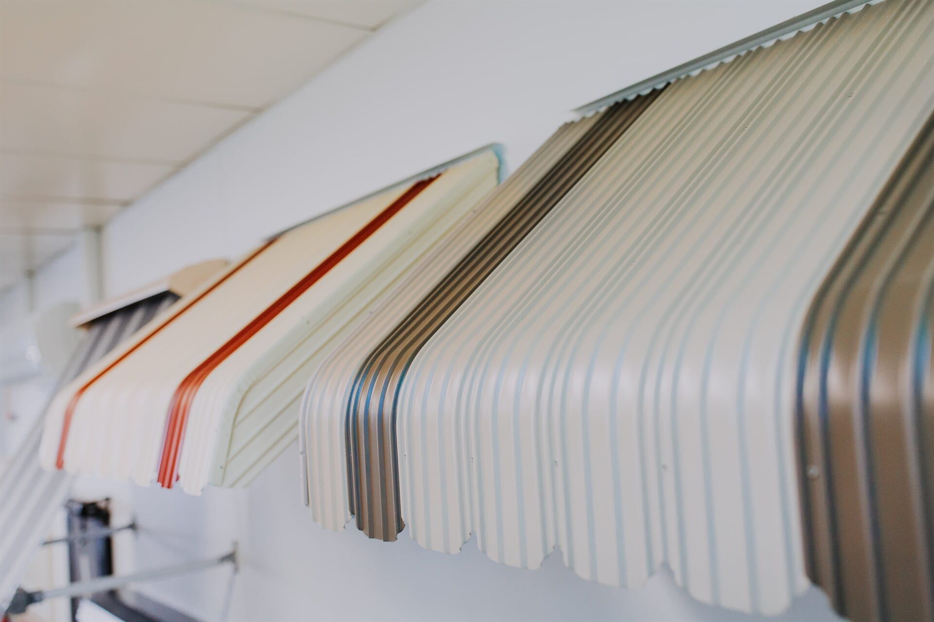 A Row of Awnings of Different Colors Are Hanging on a Wall — BTS Blinds & Awnings in Gunnedah, NSW