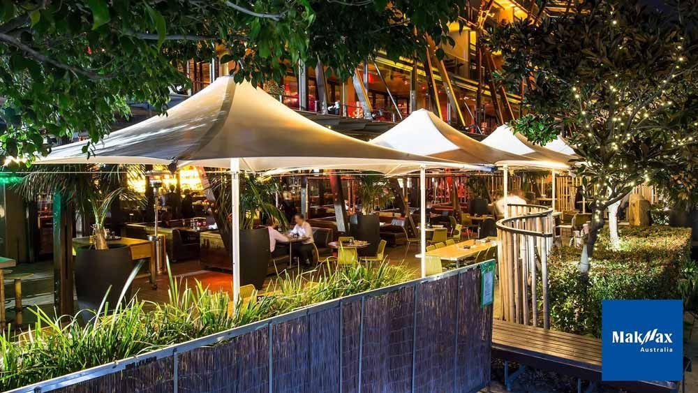 Umbrellas Installed Alongside a Restaurant — Professional Shade Sail Installation in Garbutt, QLD
