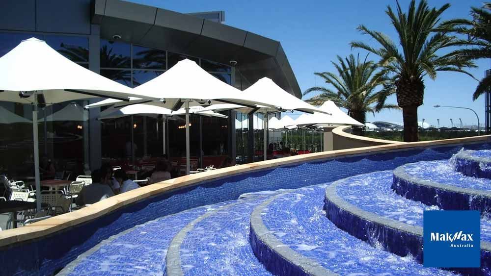 Umbrellas Installed Beside a Fountain — Professional Shade Sail Installation in Garbutt, QLD