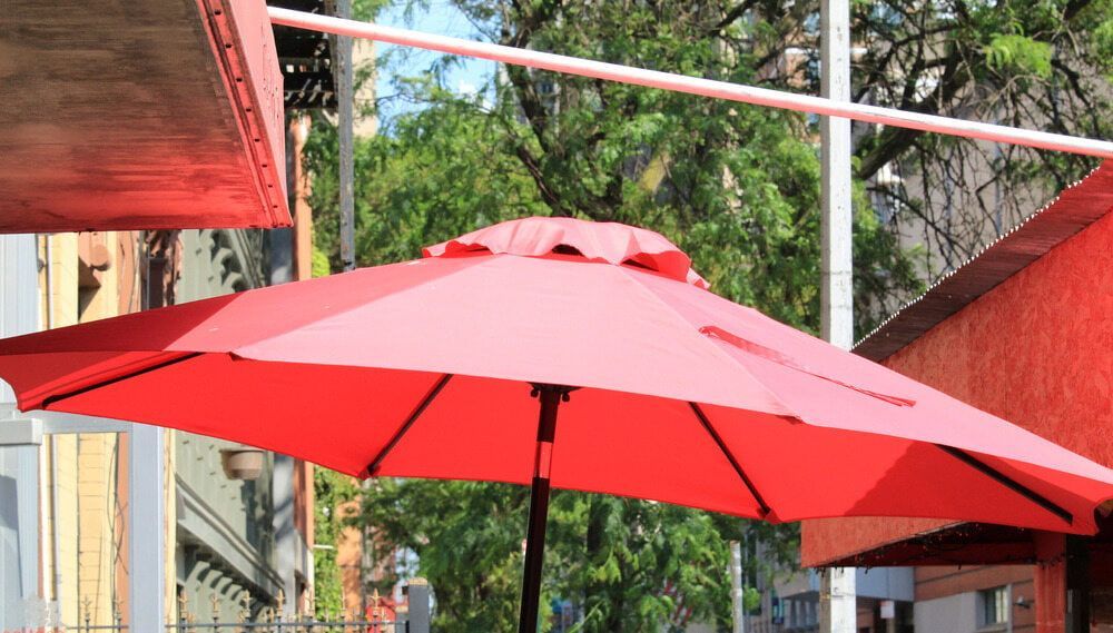 Red Patio Umbrella Open Outside — Professional Shade Sail Installation in Maroochydore, QLD