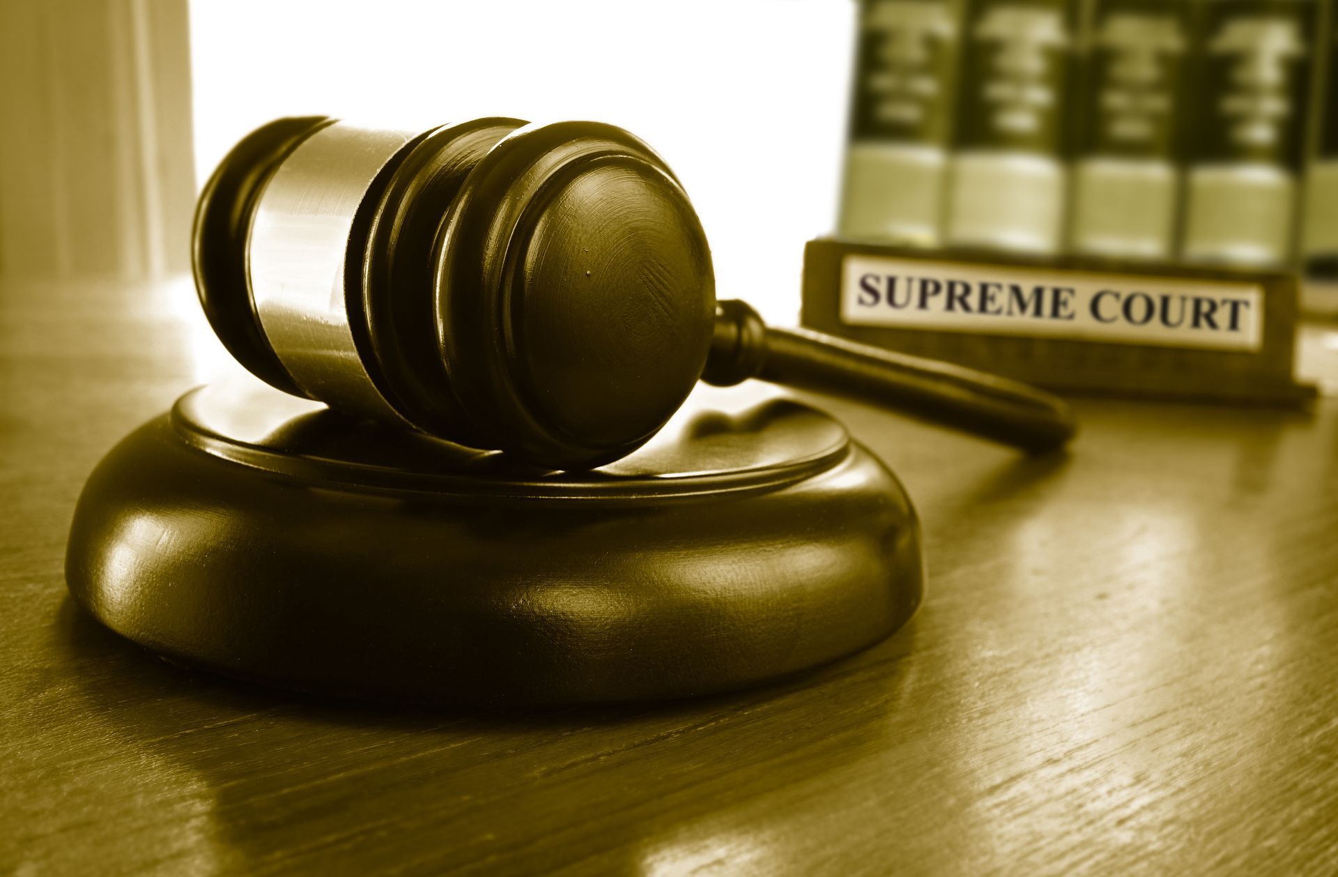 Gavel on a judge’s bench with a Supreme Court sign in the background