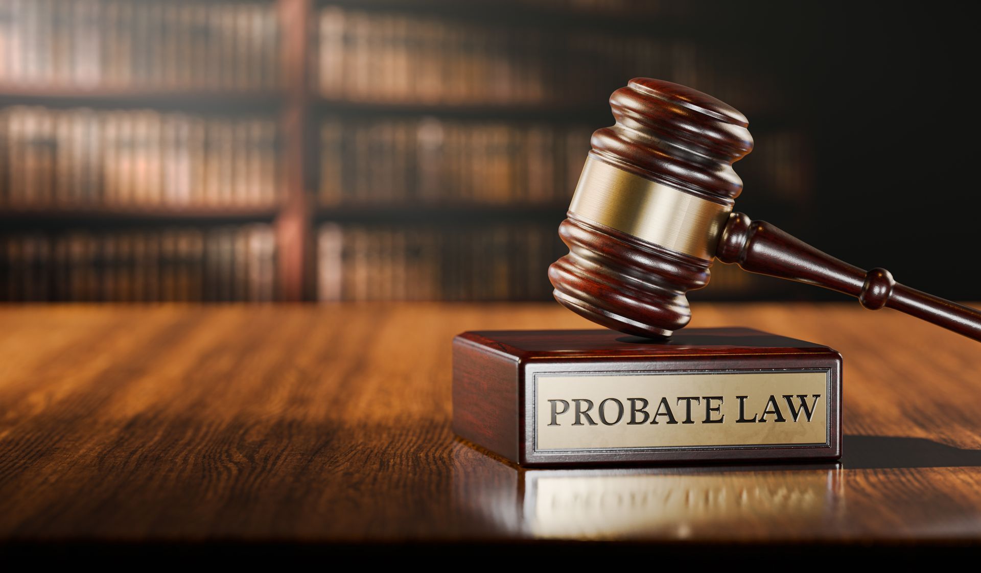 A wooden gavel over a stand with the words “probate law” engraved on a gold plate in a library