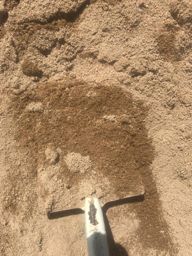 A Shovel is Sitting on Top of a Pile of Sand — Chooks Sand And Gravel In Paget, QLD