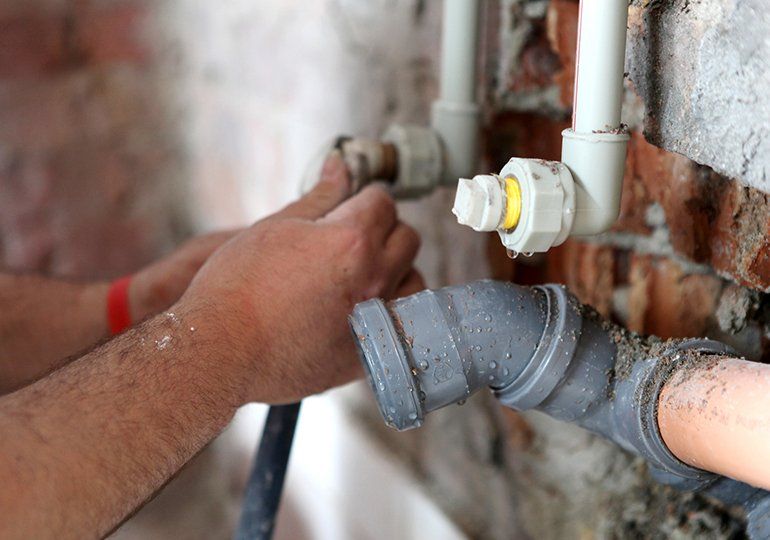 Plumber Working On Pipes — Sergeant Bluff, IA — Speedy Rooter Plumbing Plumber Working On Pipes — Sergeant Bluff, IA — Speedy Rooter Plumbing