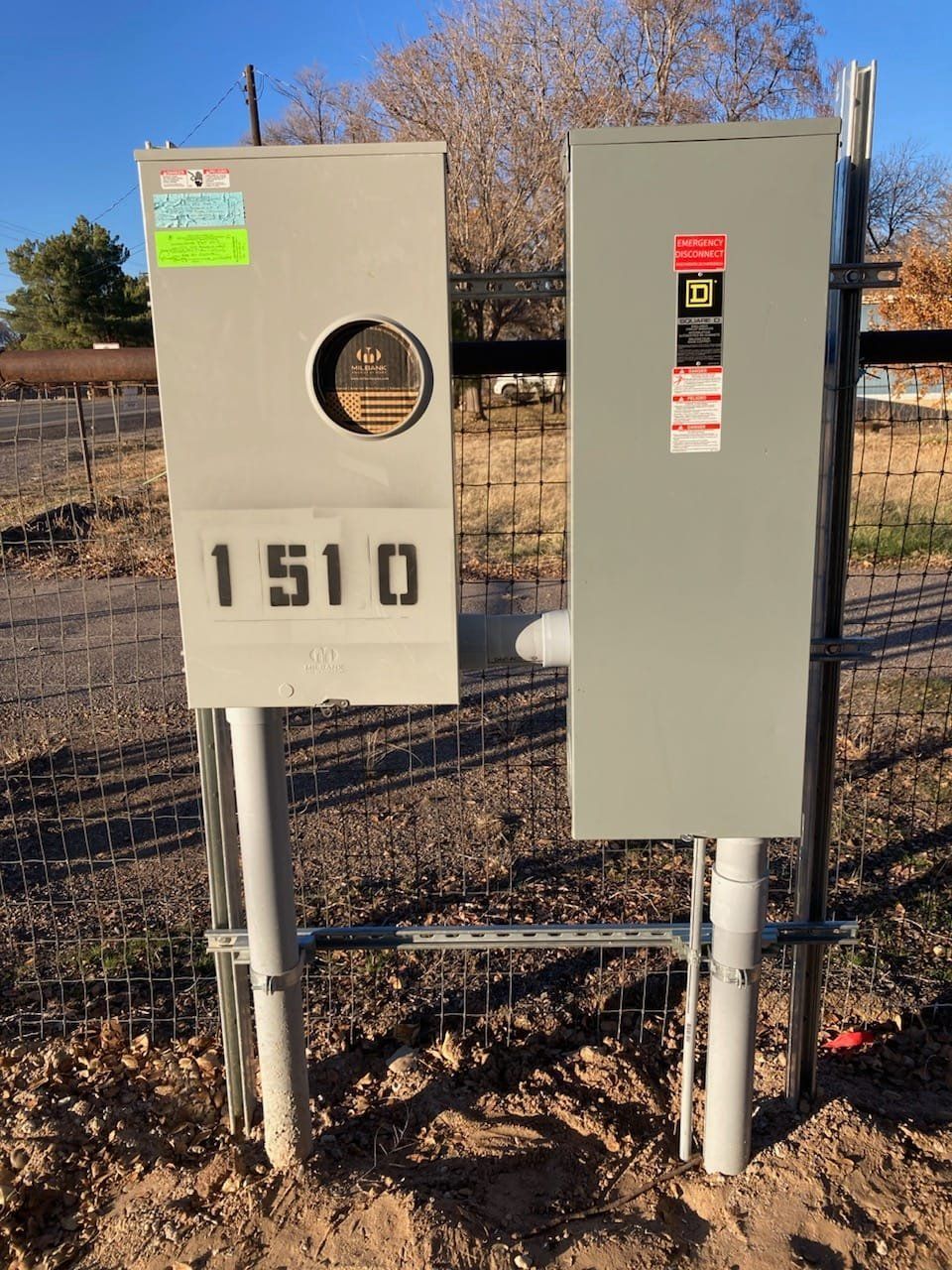 Two electrical utility cabinets with meters and warning labels outdoors, one marked 1510.