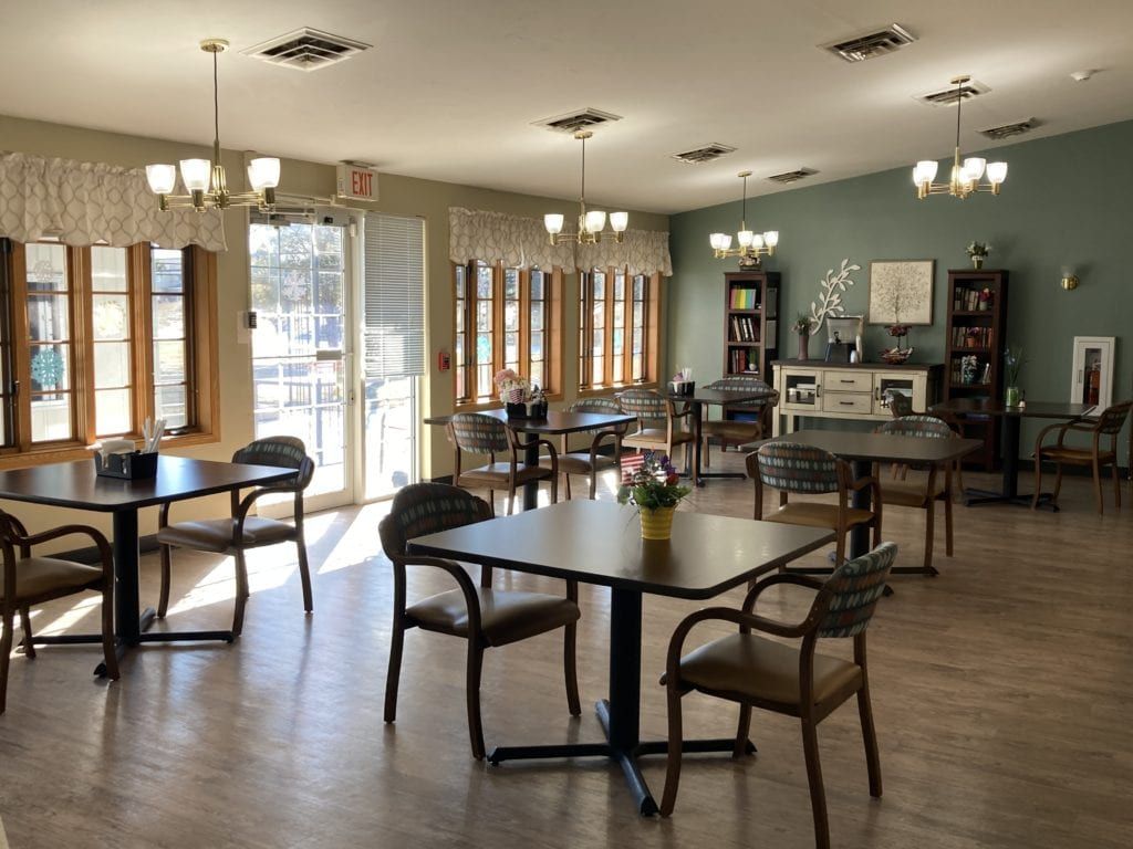 A large room with tables and chairs in it.