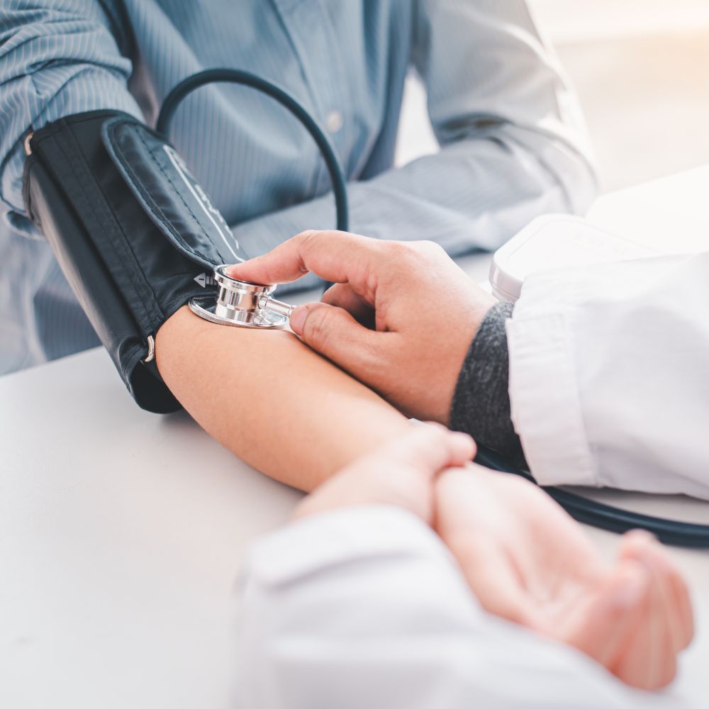 A person with a blue bandage on their arm