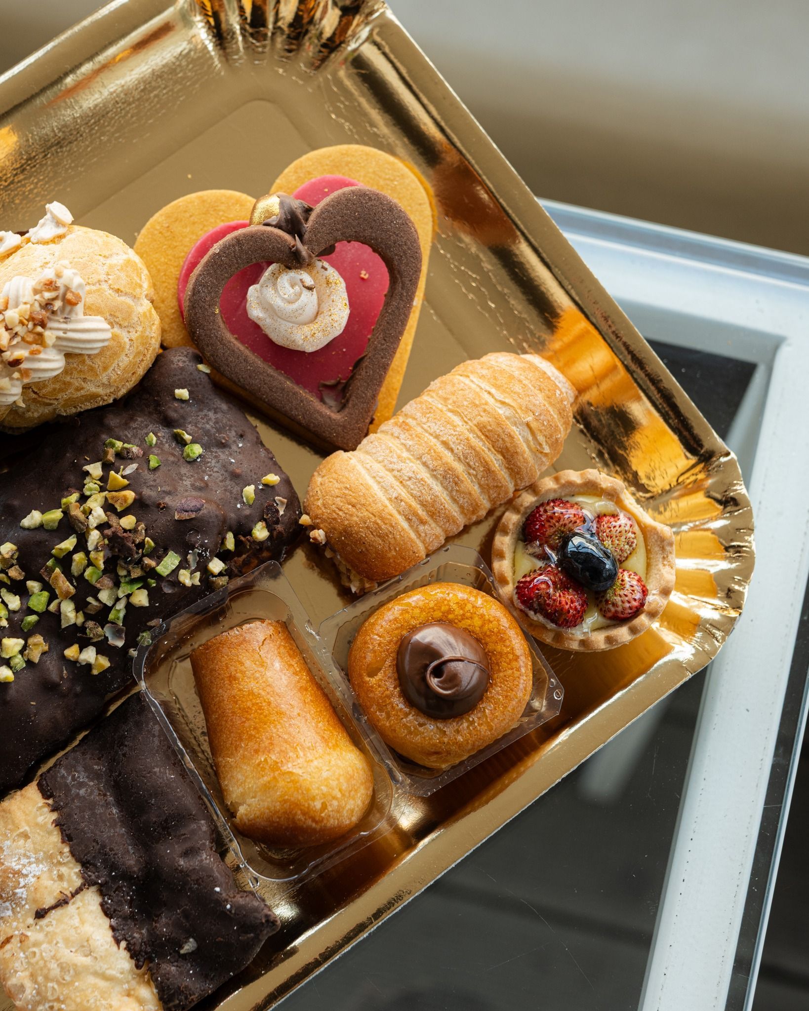 vassoio di pasticcini tra cui babà, biscotti, cannoncini