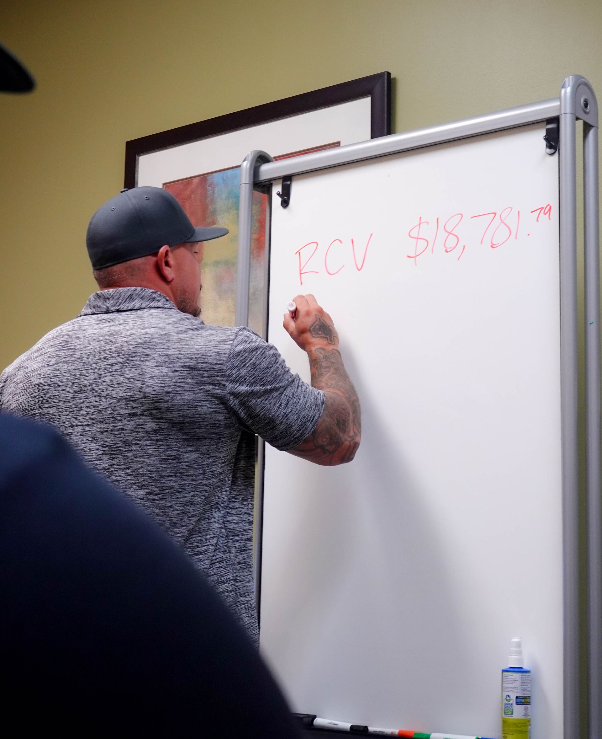 Man with tattoos writing