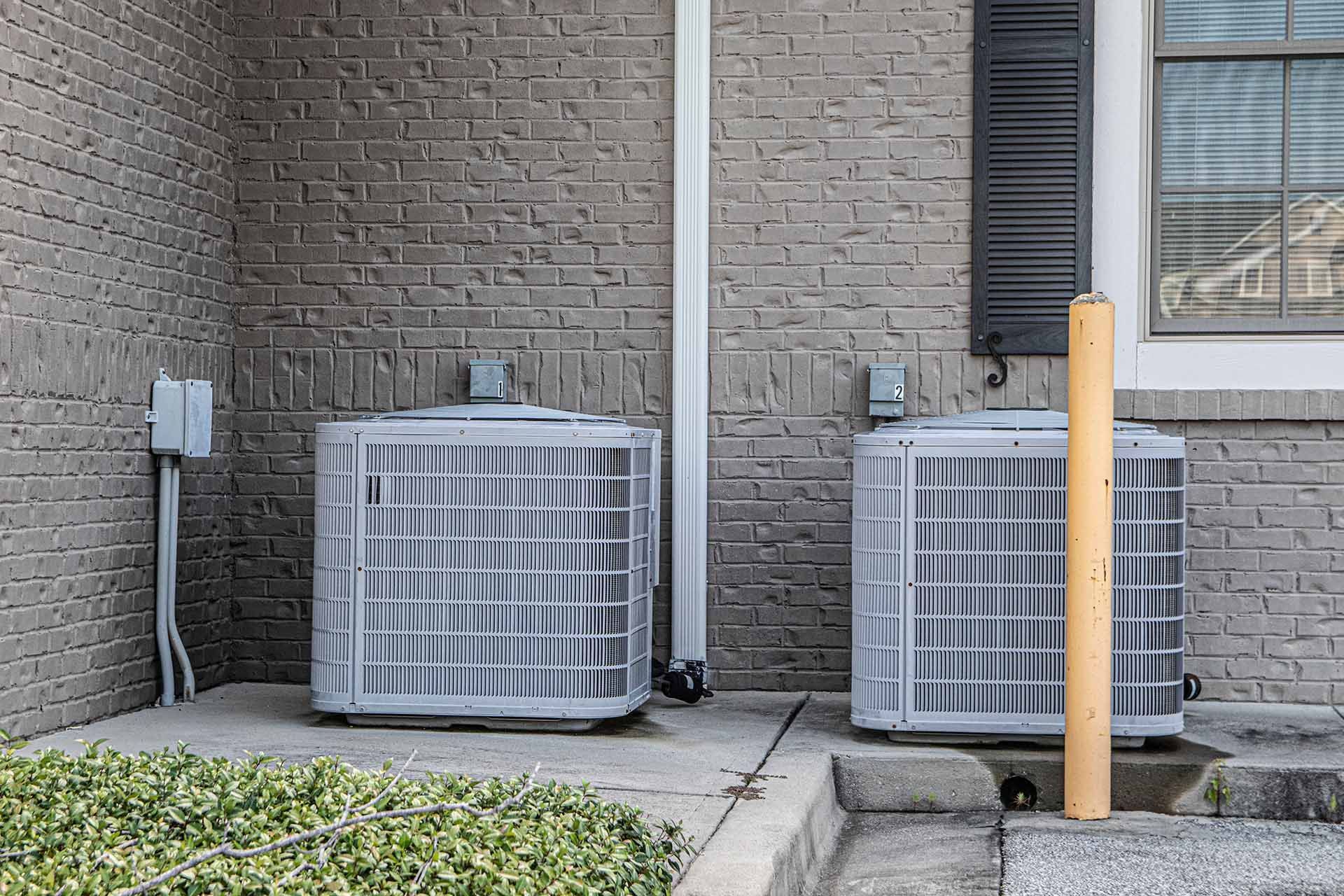 Row of outdoor residential air conditioning units.