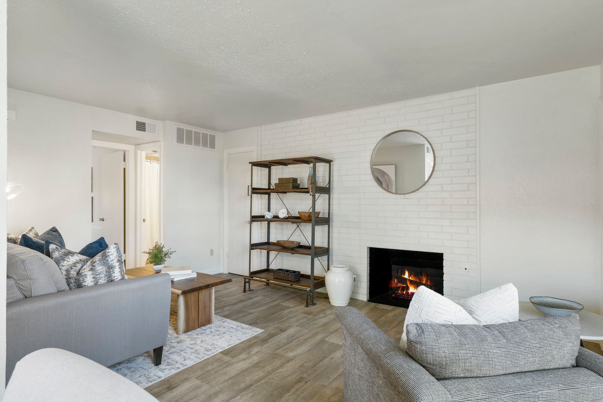 living room with shelving and fireplace
