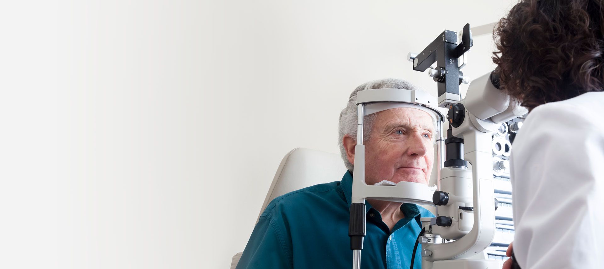 Patient being examined with a slit lamp by an eye doctor in a clinic