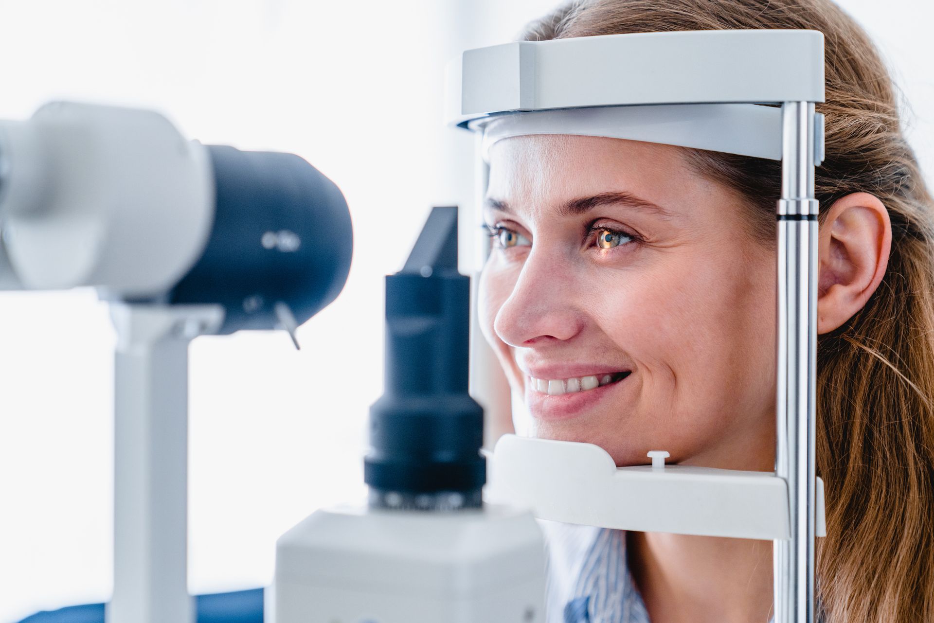 A woman is getting her eyes examined by an ophthalmologist.