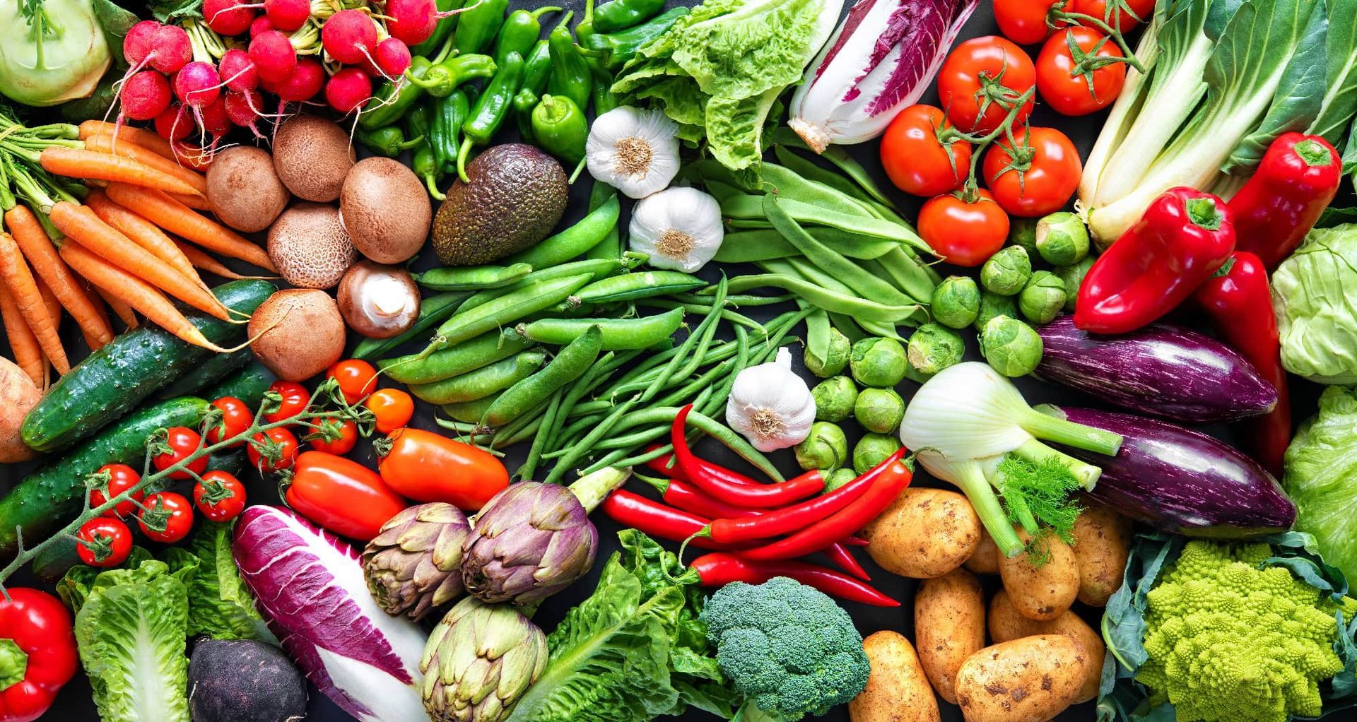 There are many different types of vegetables on the table.