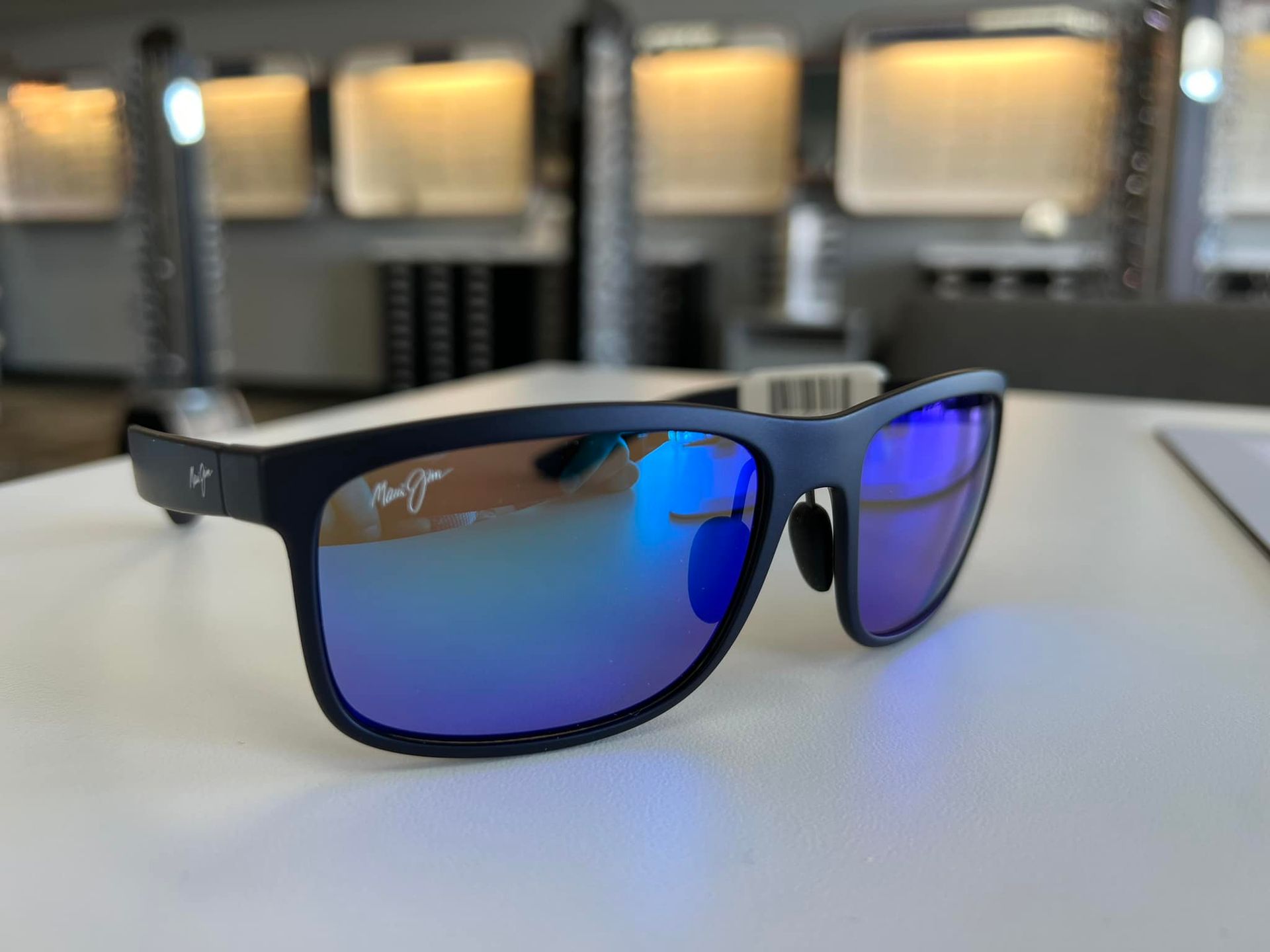 a pair of blue Maui Jim sunglasses on a table at Pro Optical in West Lebanon, NH