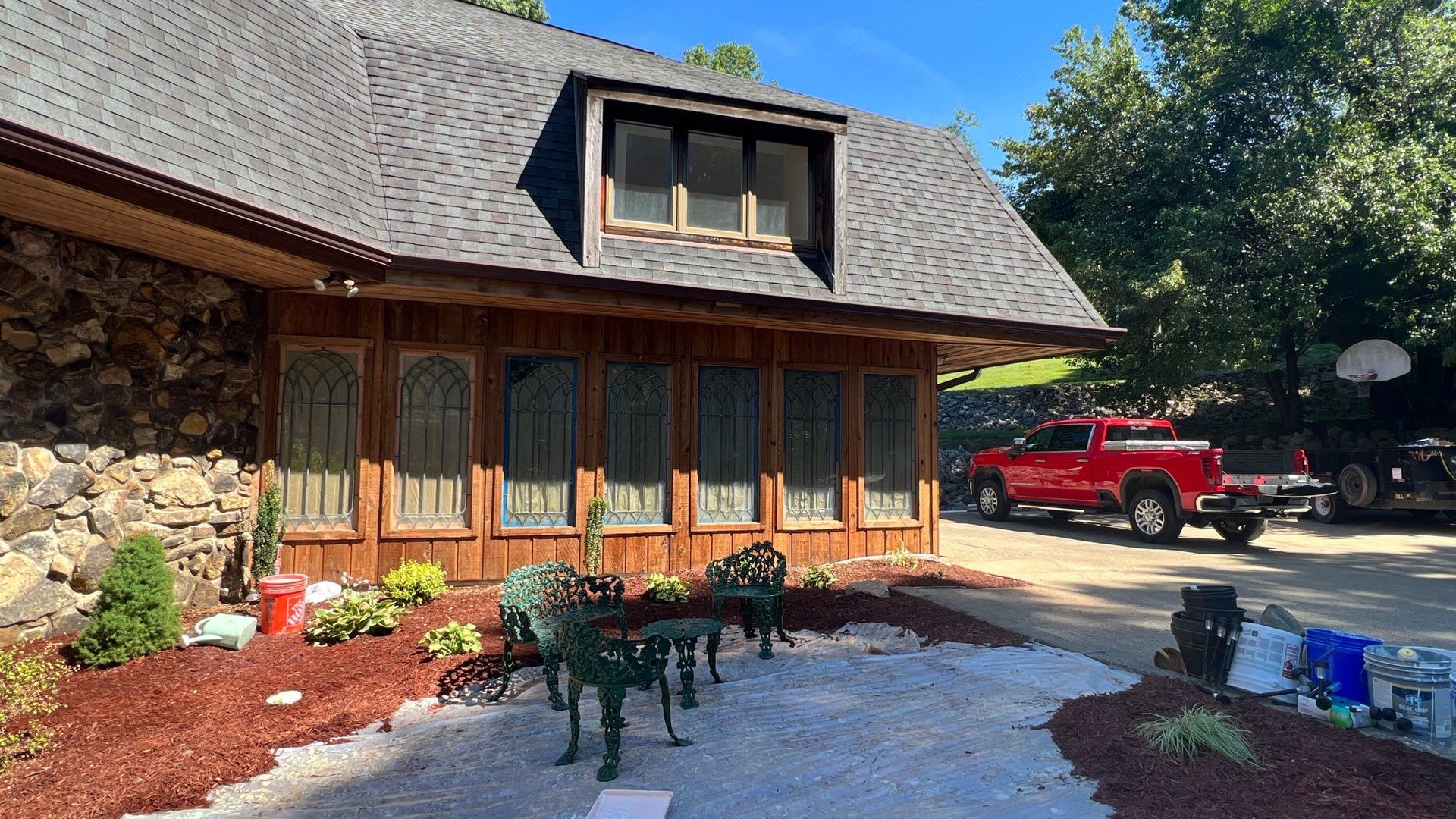 A large house with a lot of windows and a red truck parked in front of it.