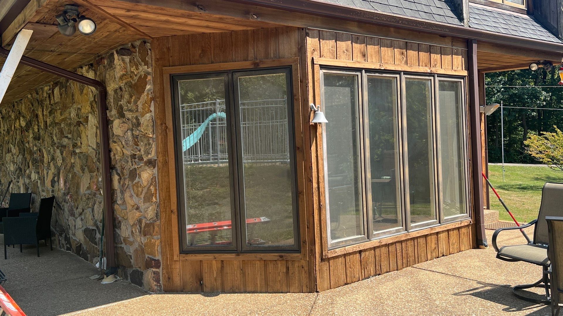 A house with a lot of windows on the side of it.