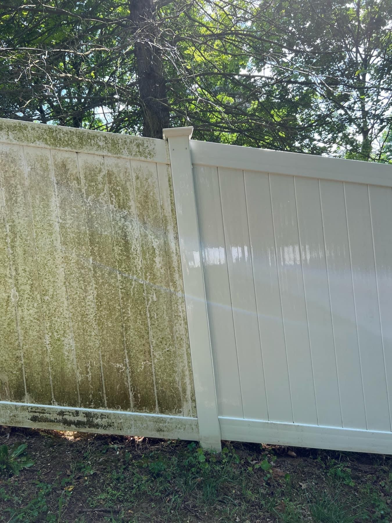 A white fence with a dirty side and a clean side.