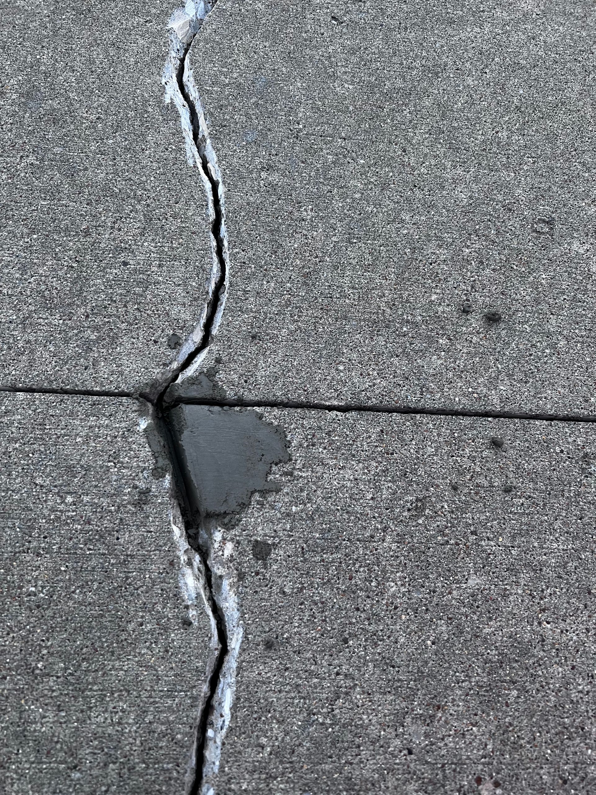 A close up of a cracked concrete surface