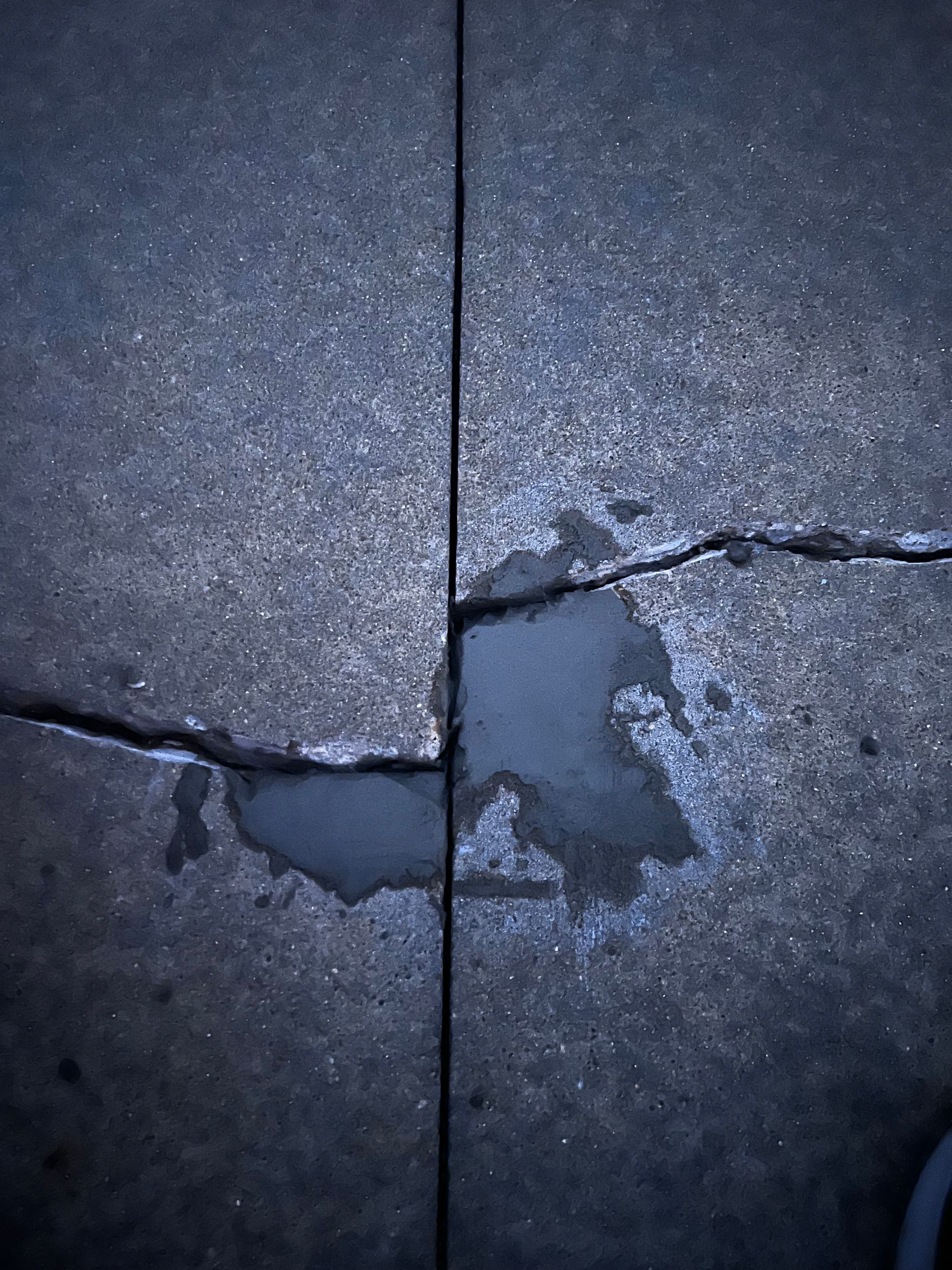 A close up of a cracked concrete surface