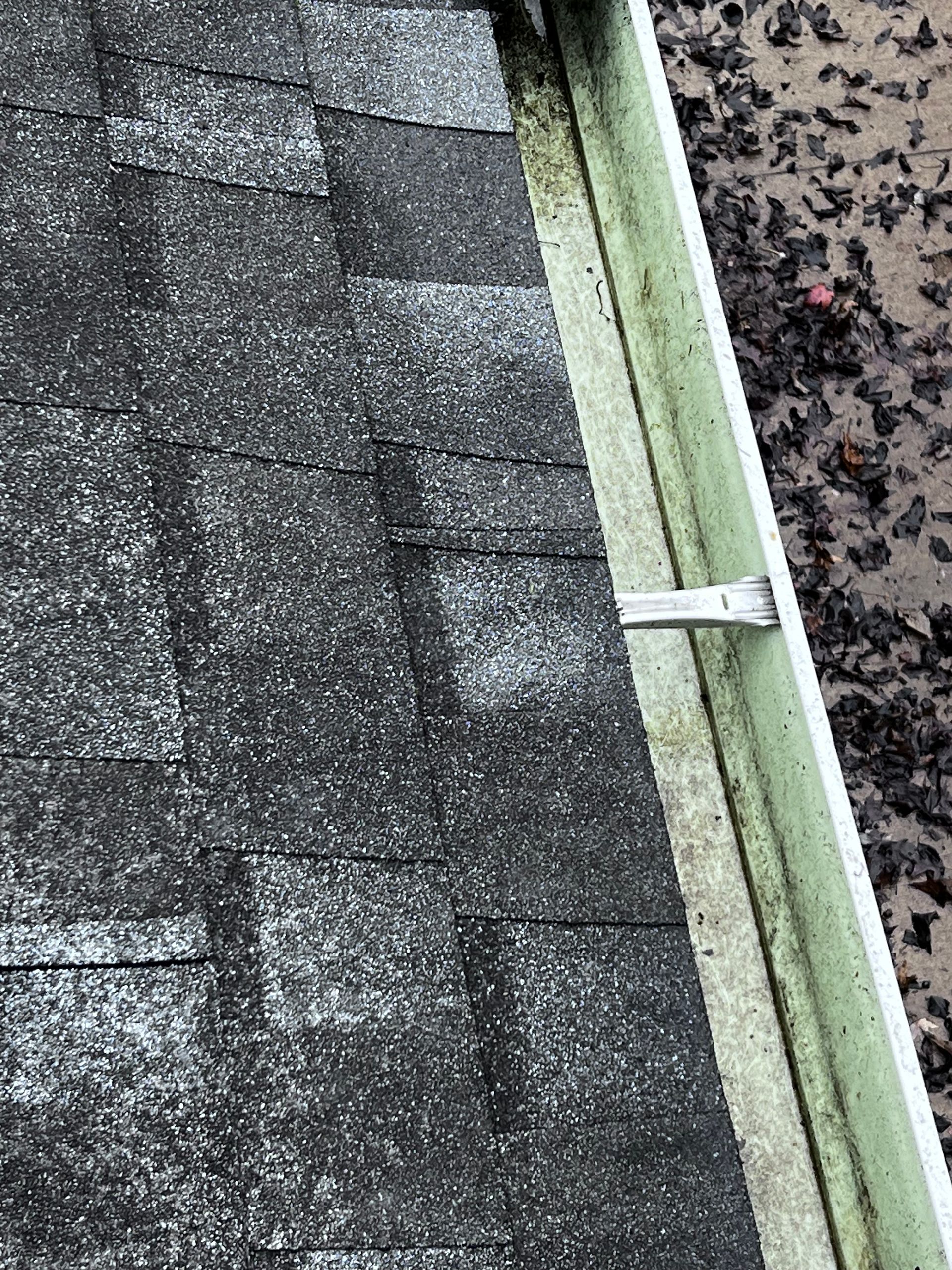 A close up of a gutter on a roof.