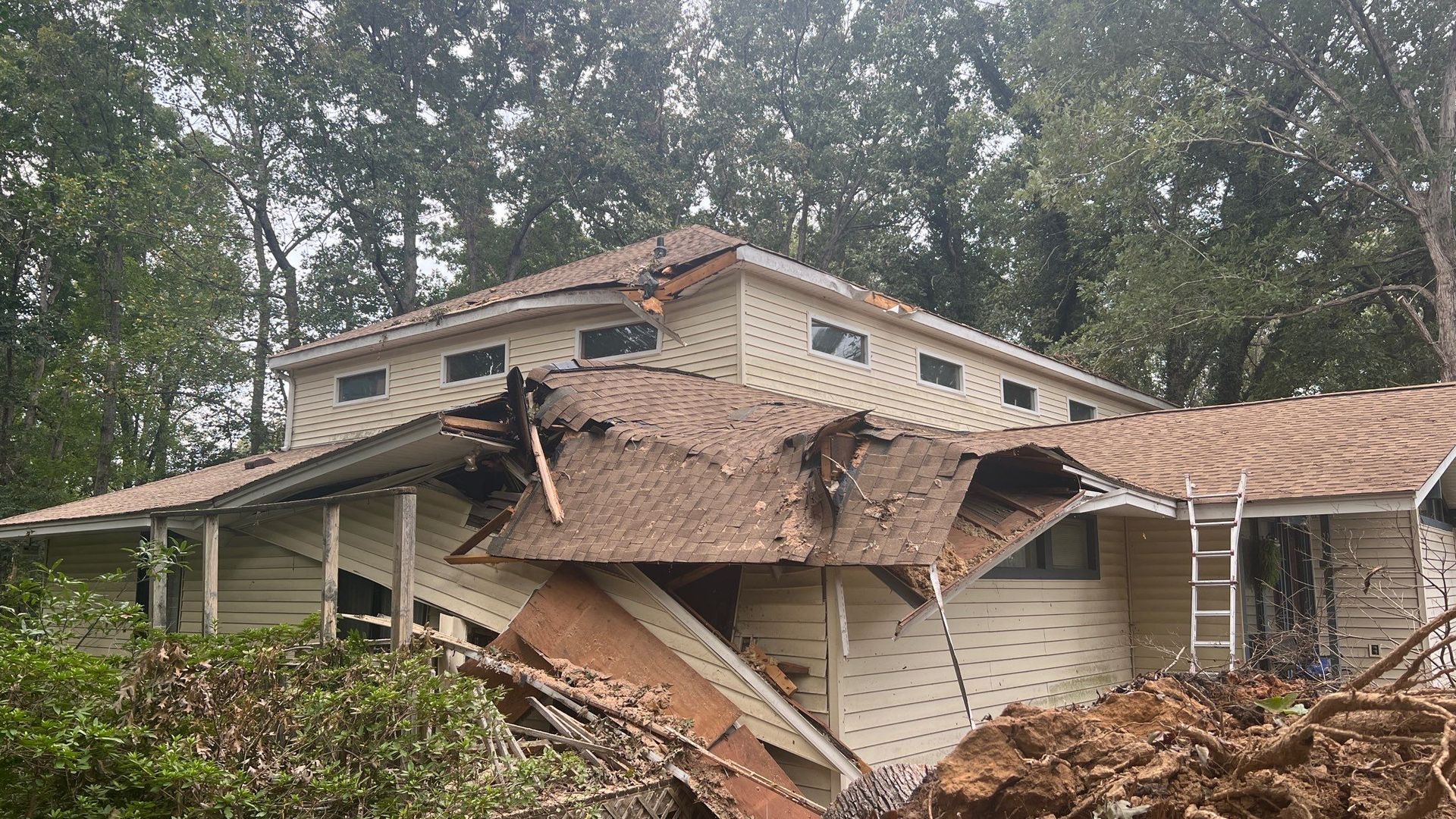 A house with a roof that has collapsed.