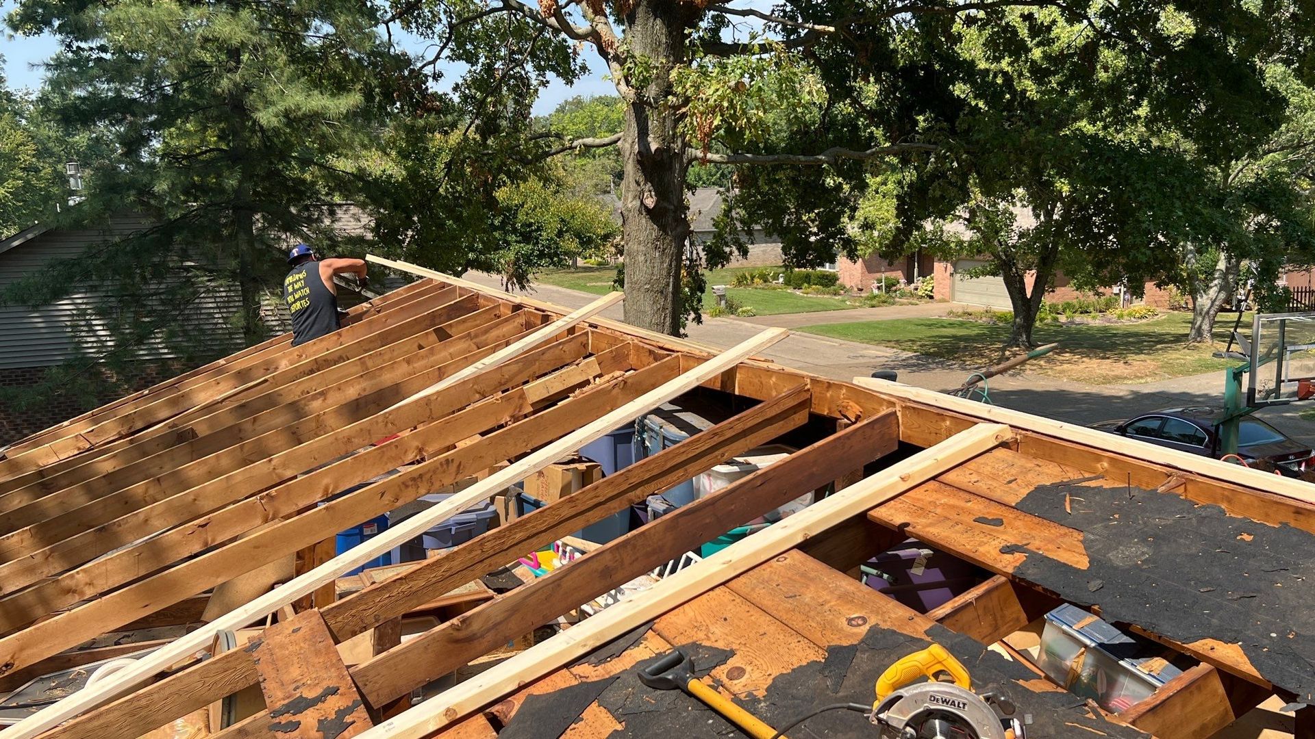A man is working on the roof of a house.