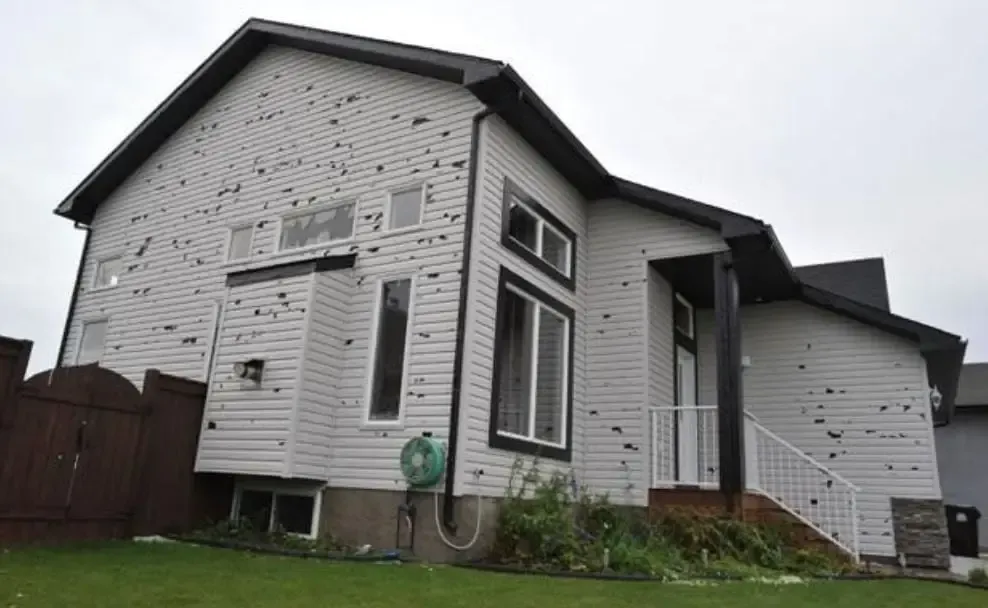 A house with hail damage in the siding.