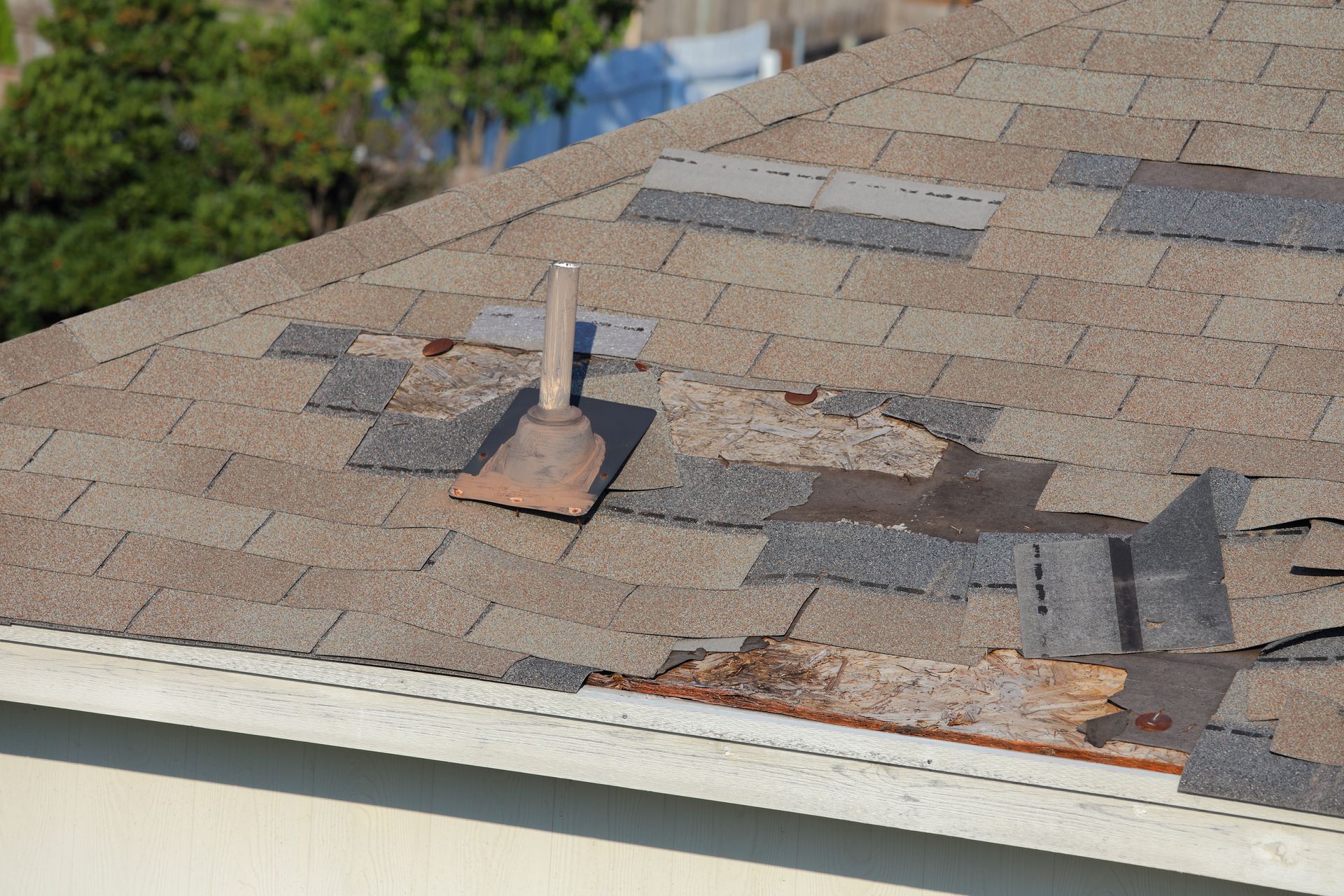A roof with a hole in it shingles missing.