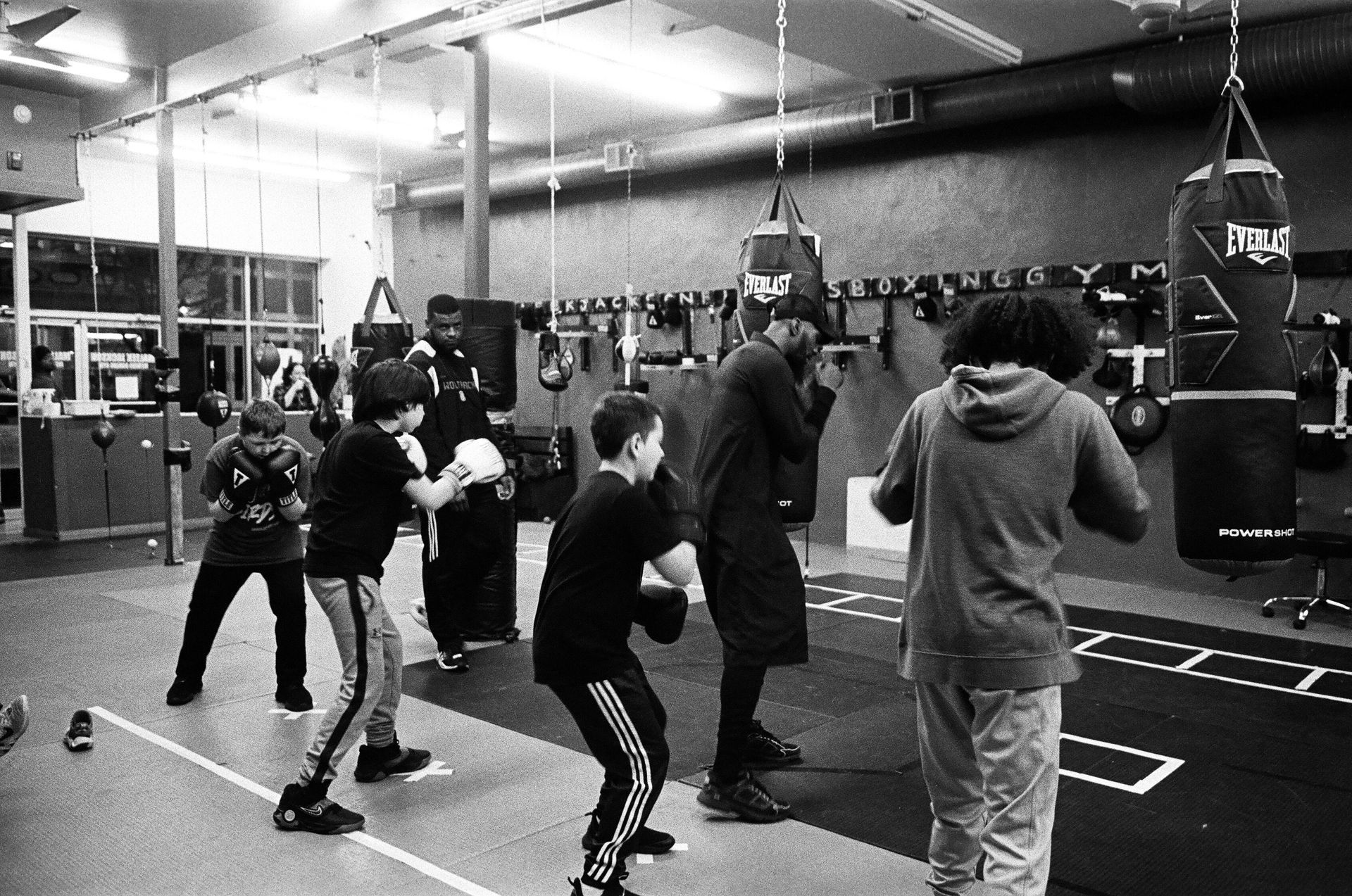 A group of people are boxing in a gym.