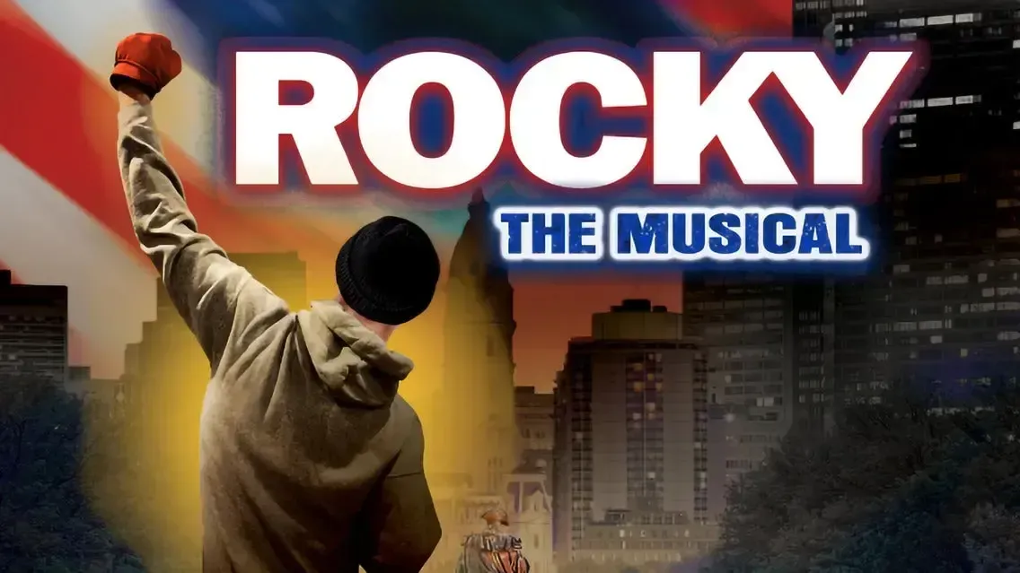 A poster for rocky the musical shows a man raising his fist in the air