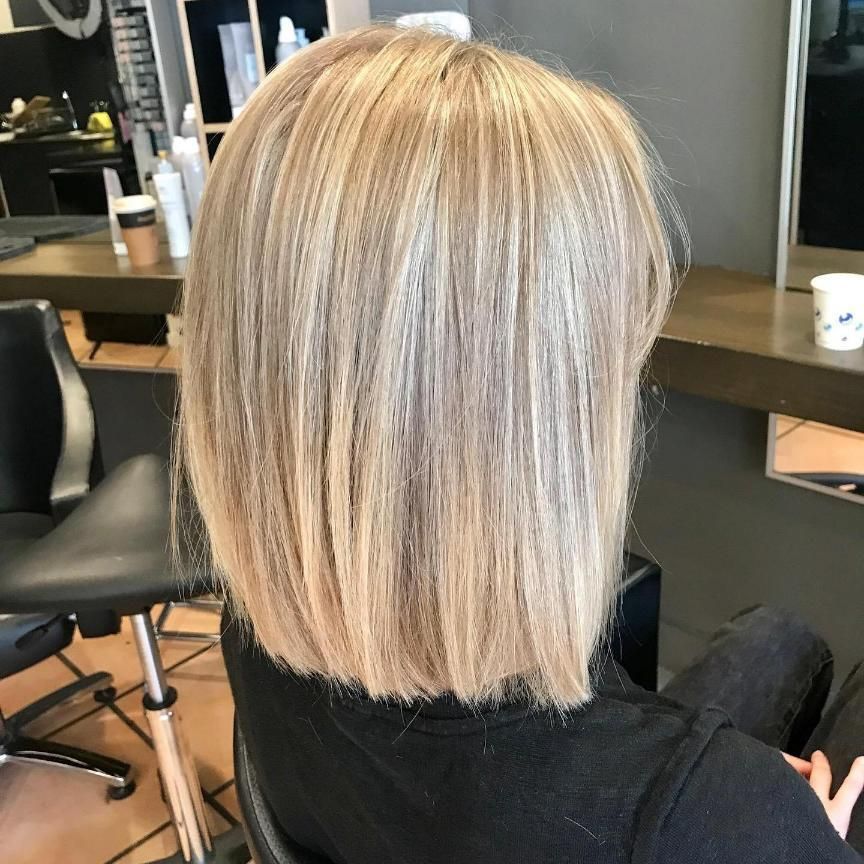 A Woman With Blonde Hair is Sitting in a Chair in a Salon — Energy Hair Co in Noosa Heads, QLD