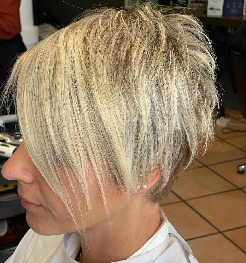 A Woman With Short Blonde Hair is Getting Her Hair Cut — Energy Hair Co in Noosa Heads, QLD