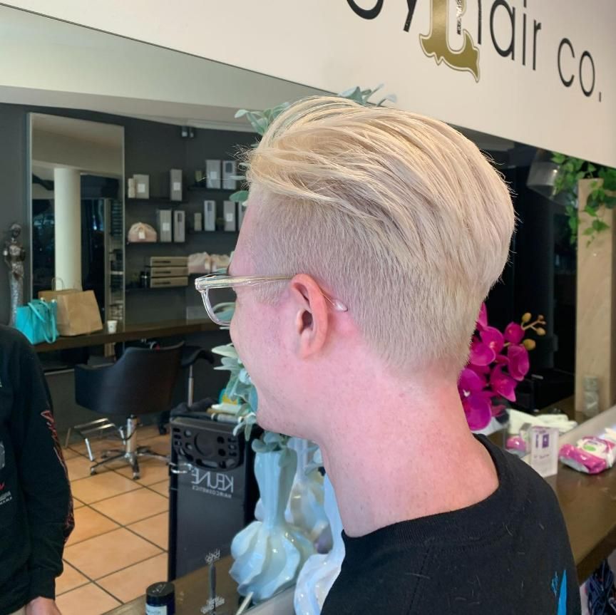 A Man With Blonde Hair is Standing in a Hair Salon — Energy Hair Co in Noosa Heads, QLD