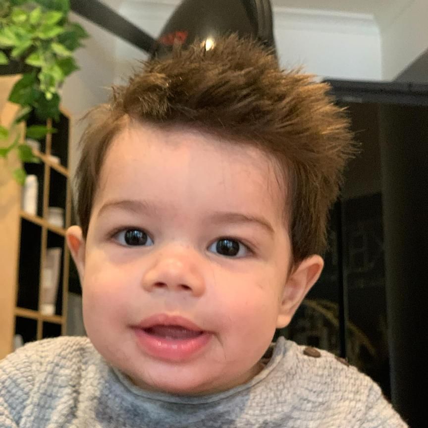 A Baby is Wearing a Grey Sweater and Looking at the Camera — Energy Hair Co in Noosa Heads, QLD