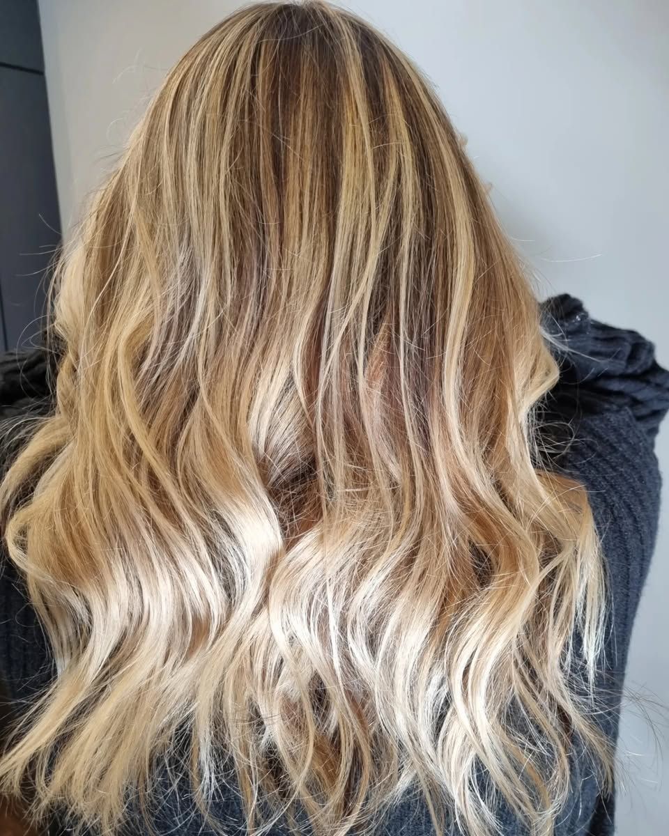 A Woman is Getting Her Hair Cut by a Hairdresser in a Salon — Energy Hair Co in Noosa Heads, QLD